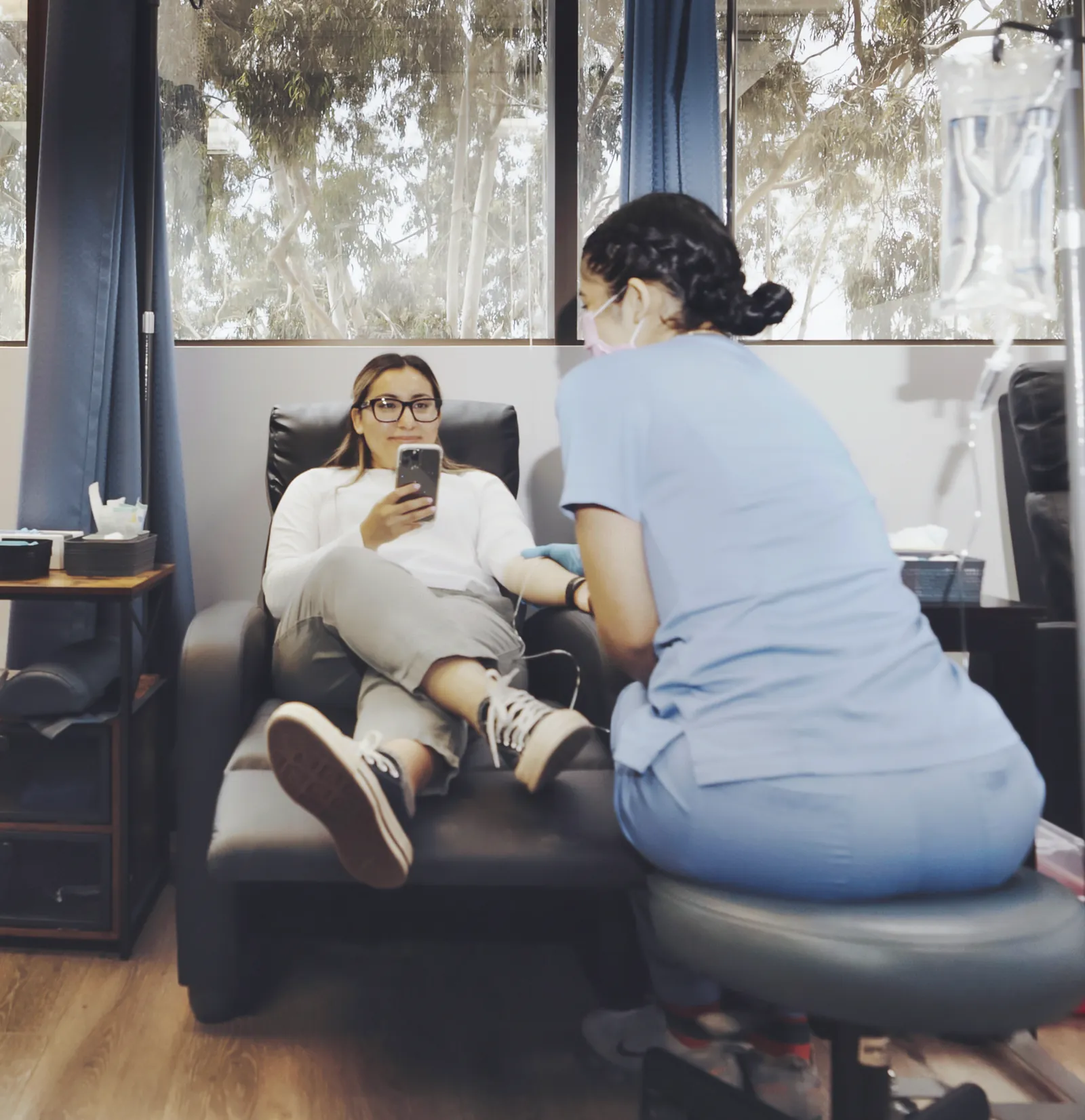 A K Wellness staff member with a client relaxing in an IV chair
