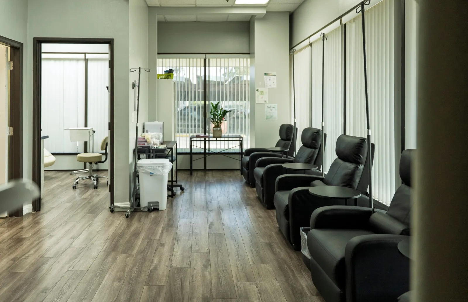 Reclining chairs with side tables and IV poles in the K Wellness IV room